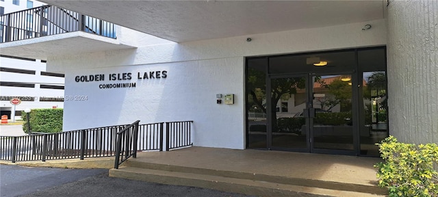 1900 Diana Dr Unit 3E, Hallandale Beach, FL 33009 - view of exterior entry with french doors and stucco siding