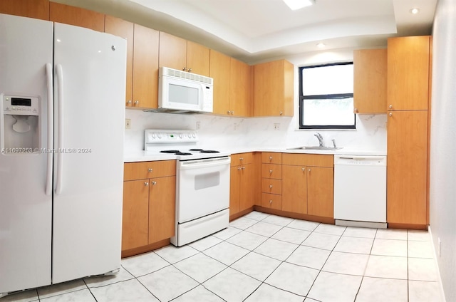 kitchen with light tile patterned floors, white appliances, and sink