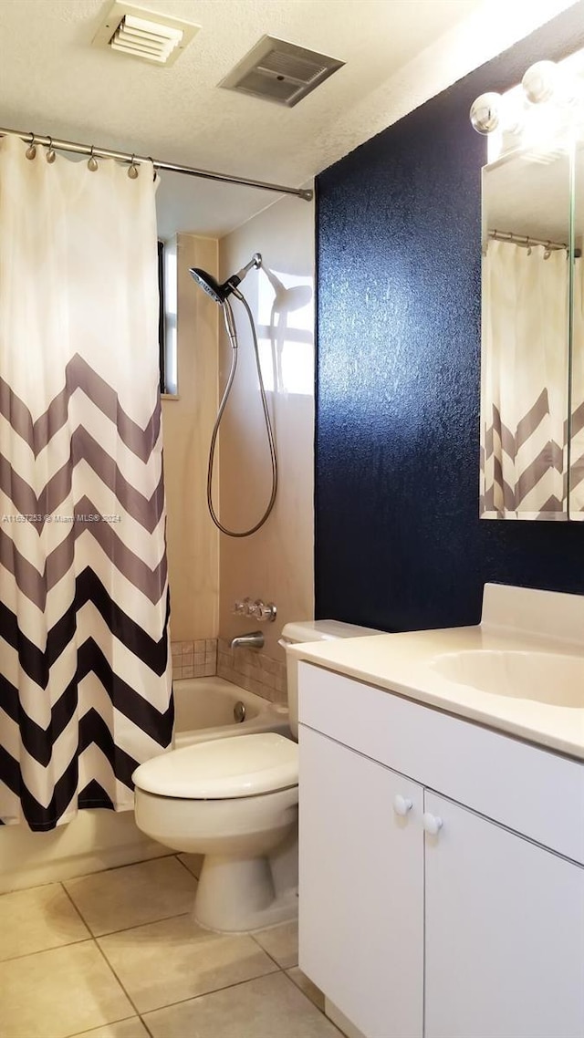 full bathroom featuring tile patterned flooring, shower / tub combo, vanity, and toilet