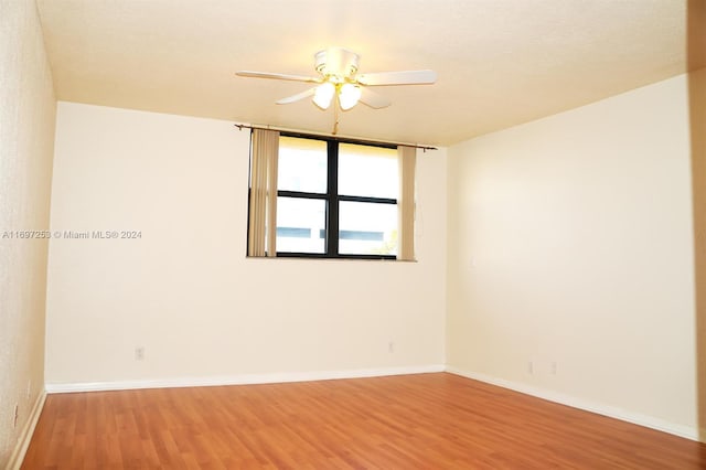 spare room featuring hardwood / wood-style floors and ceiling fan