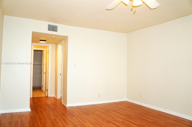 empty room with hardwood / wood-style flooring and ceiling fan