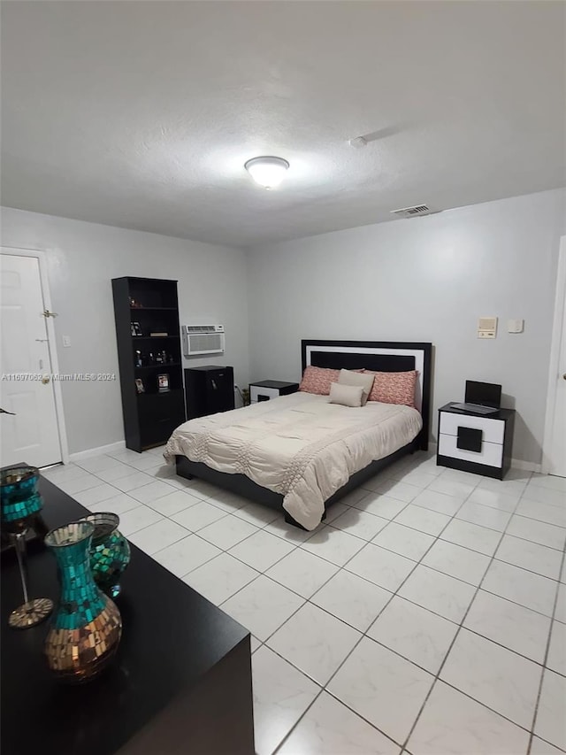 tiled bedroom with a wall mounted AC