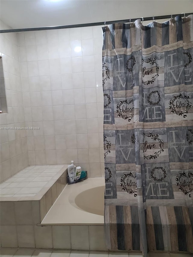 bathroom featuring tile patterned floors and tiled bath