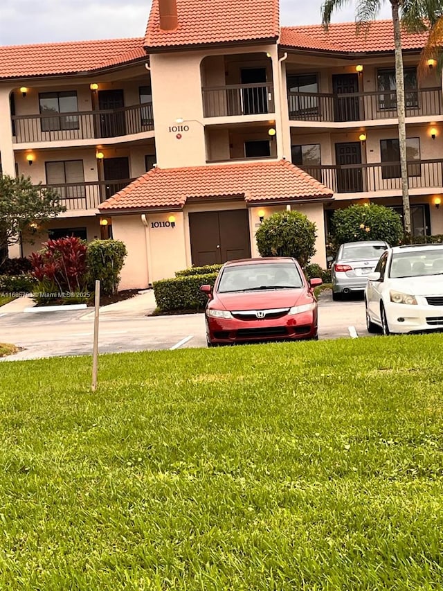 view of building exterior with uncovered parking