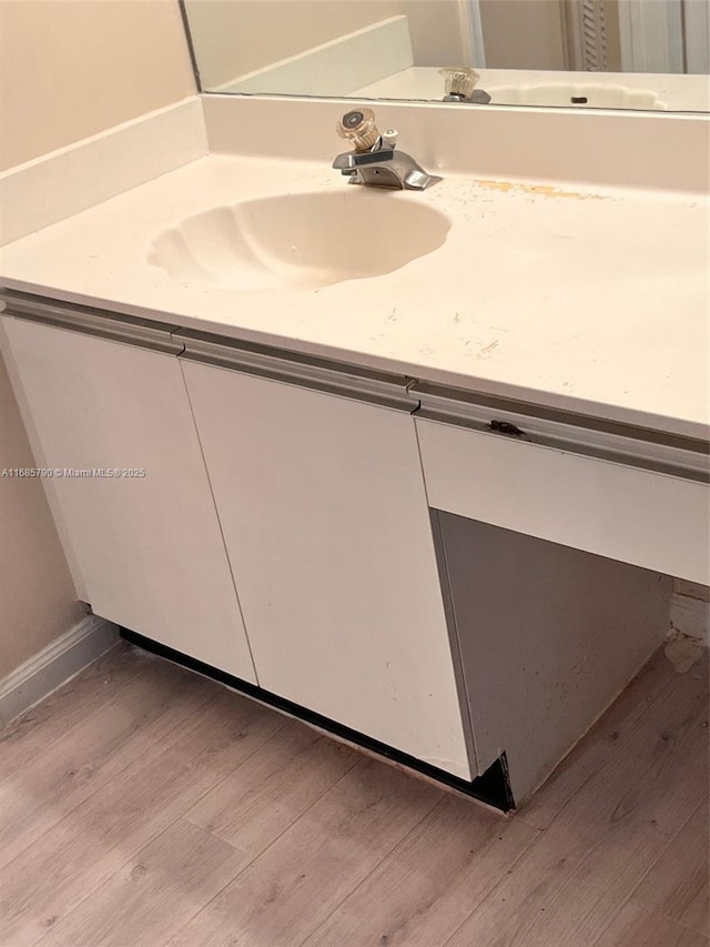 bathroom with vanity and hardwood / wood-style flooring