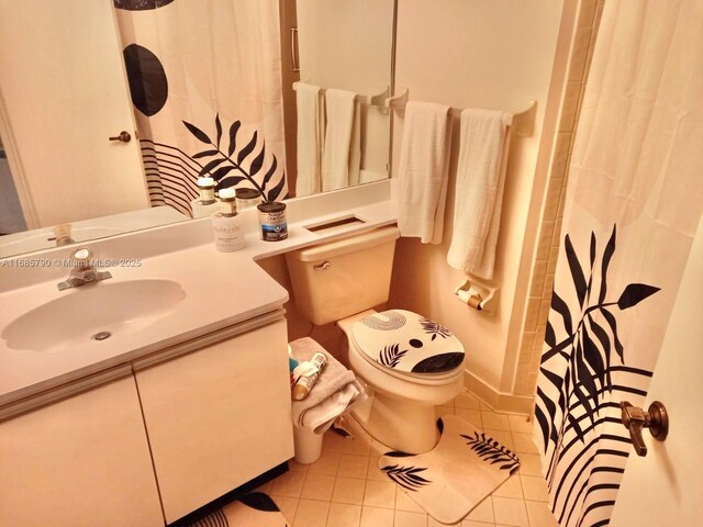 bathroom with a shower with shower curtain, vanity, toilet, and tile patterned flooring