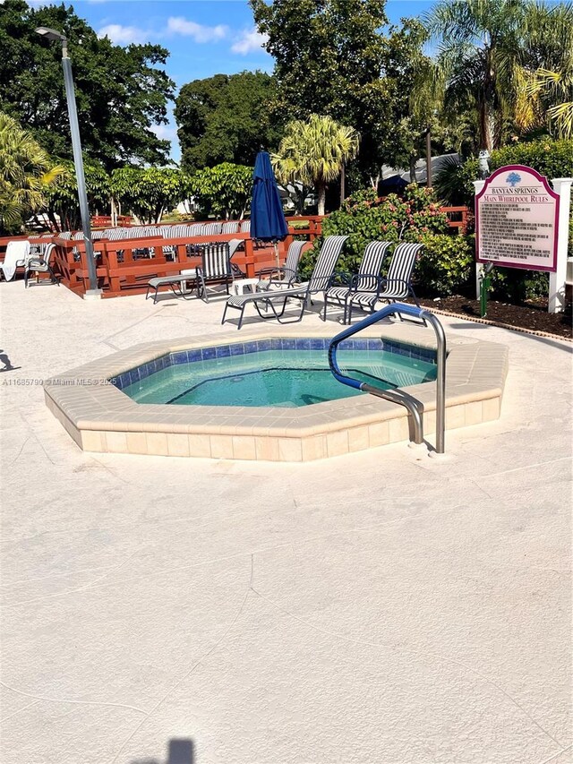 view of swimming pool with a community hot tub