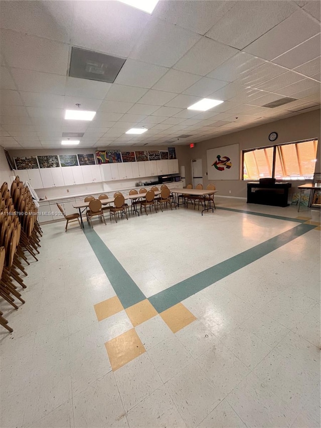 game room with a drop ceiling