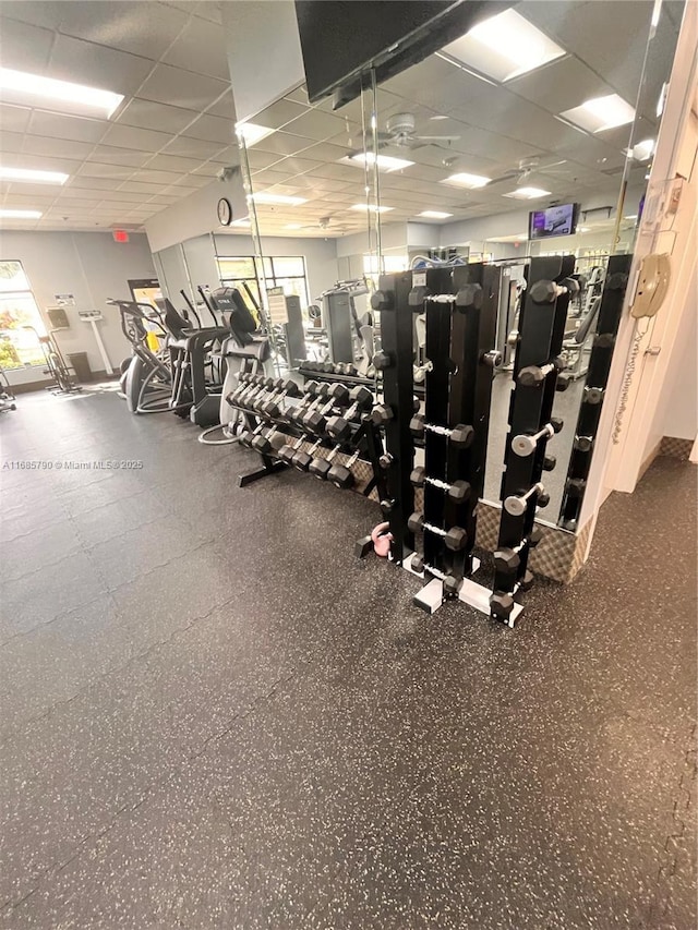 gym with a paneled ceiling