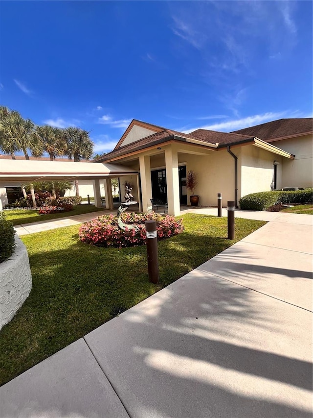 view of property exterior with a lawn