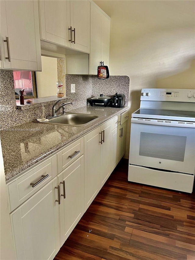 kitchen featuring dark wood-type flooring, sink, light stone countertops, white electric range oven, and white cabinetry