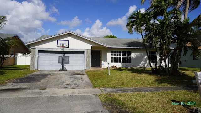 ranch-style home featuring a garage and a front lawn