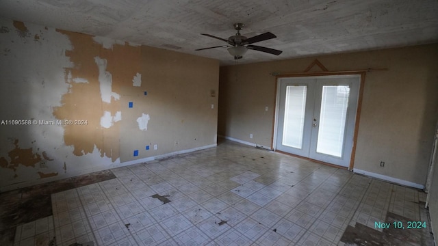 unfurnished room featuring ceiling fan and french doors