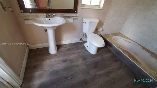 bathroom featuring a tub to relax in and toilet