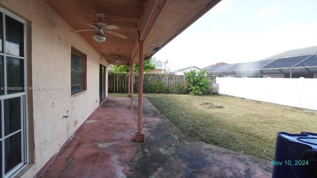 view of yard with a patio and ceiling fan