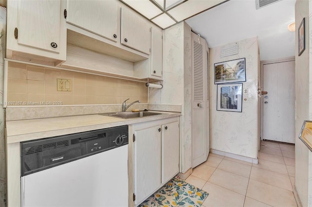 kitchen featuring dishwasher, sink, light tile patterned floors, and backsplash