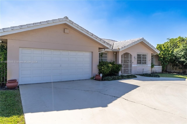 ranch-style home featuring a garage