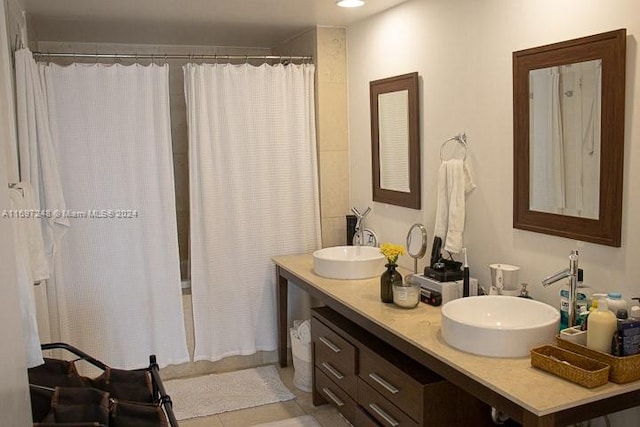 bathroom with tile patterned floors, vanity, and walk in shower