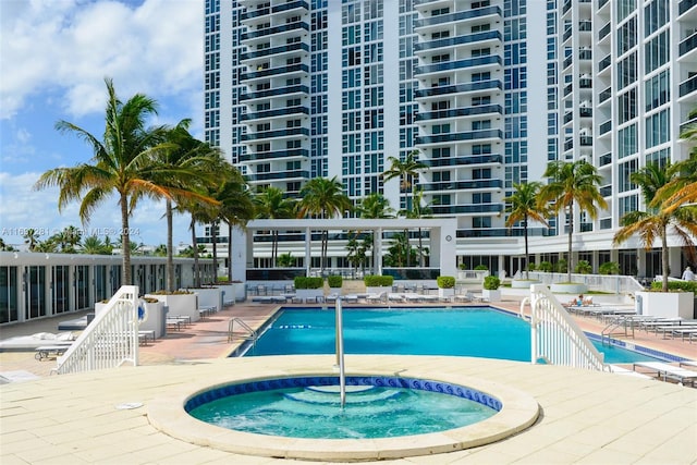 view of pool featuring a community hot tub and a patio