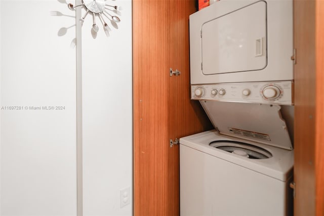 washroom featuring stacked washing maching and dryer