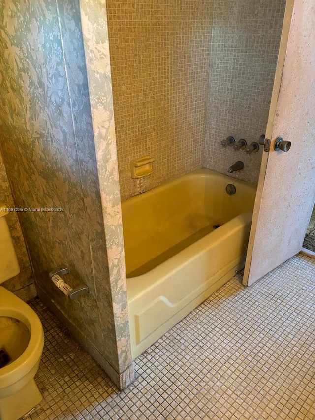 bathroom featuring tile patterned flooring and a bath