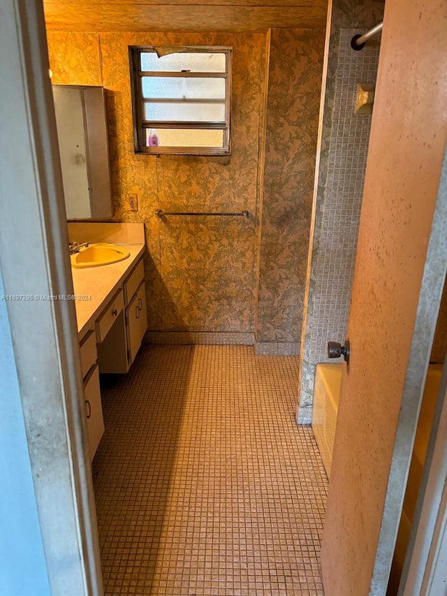 bathroom featuring vanity, tile patterned floors, and shower / washtub combination