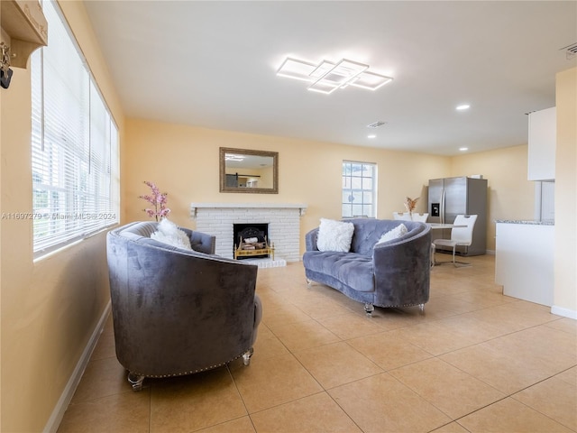 tiled living room featuring a fireplace and plenty of natural light