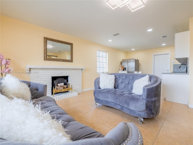 living room with sink and light tile patterned floors