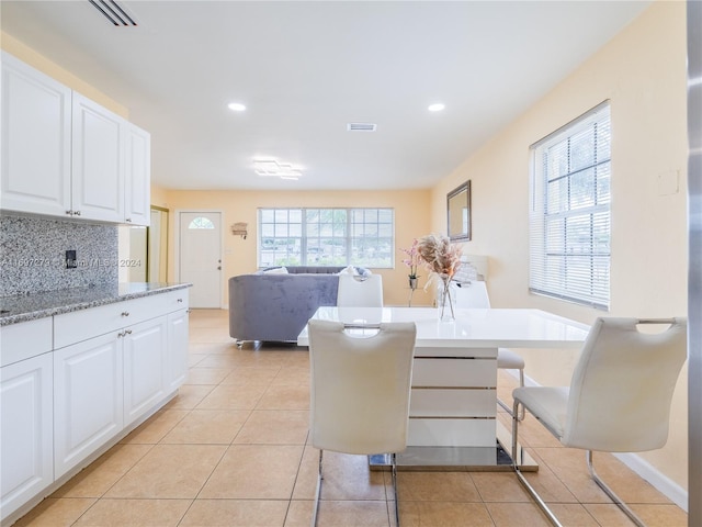 dining area with light tile patterned floors and plenty of natural light