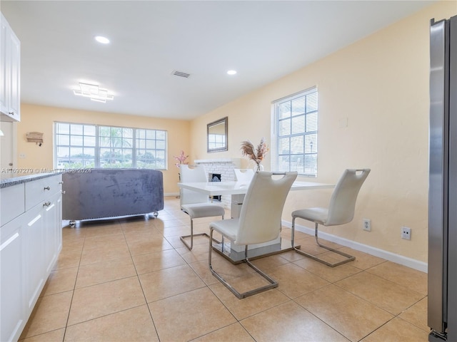 tiled dining room featuring plenty of natural light