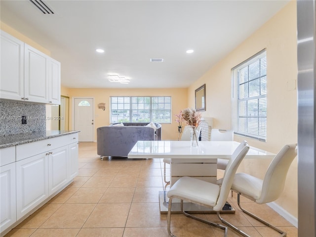 dining room with plenty of natural light and light tile patterned floors