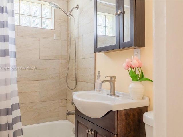 full bathroom featuring shower / bath combination with curtain, vanity, and toilet