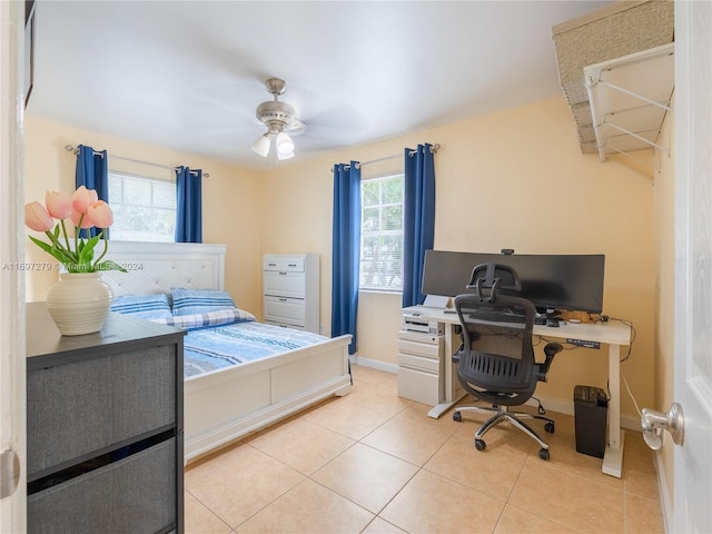 tiled bedroom with multiple windows and ceiling fan