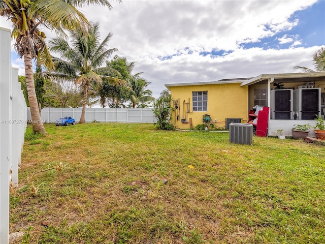 view of yard featuring central AC and a sunroom