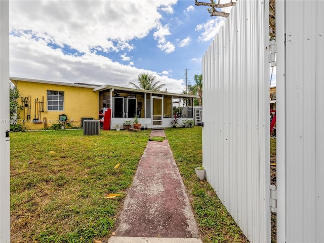 view of yard featuring a sunroom and cooling unit