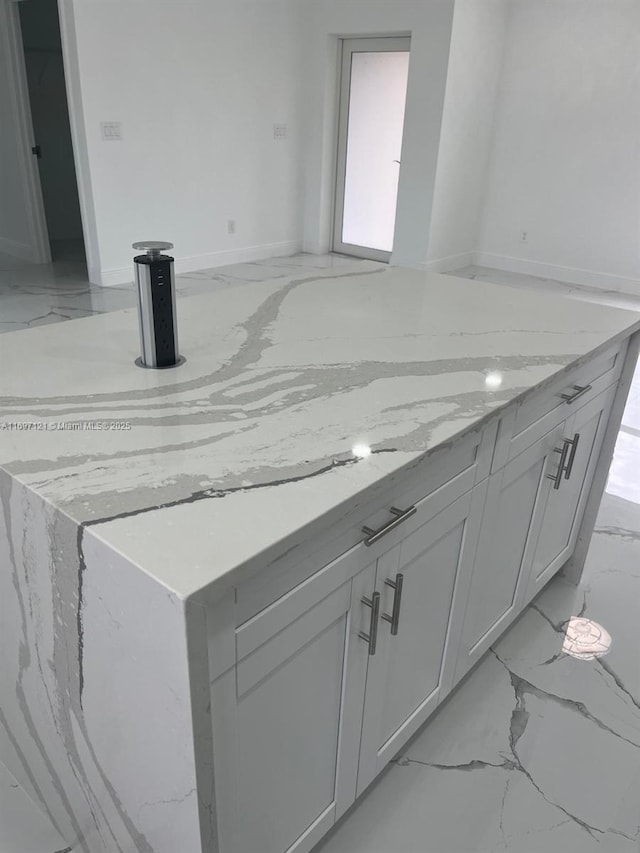 kitchen featuring light stone counters