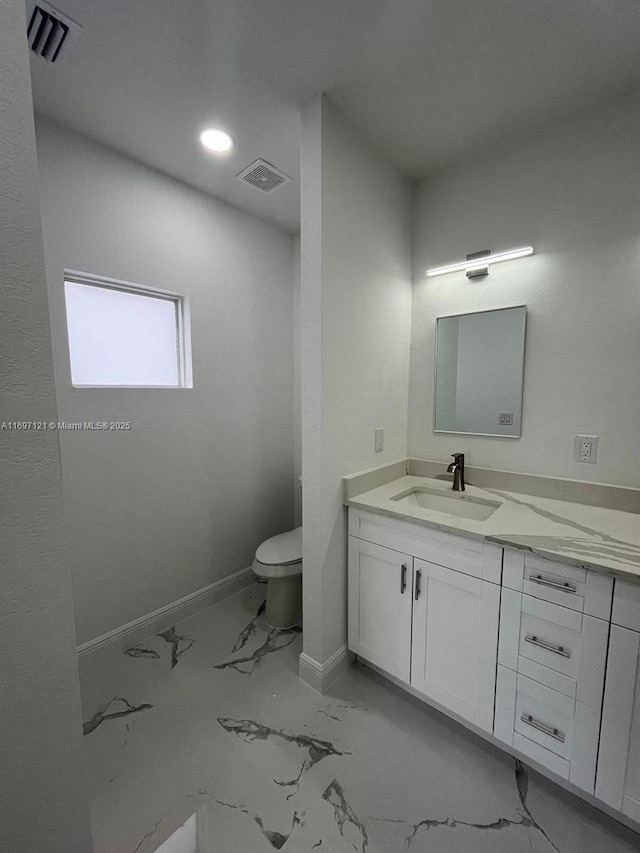 bathroom featuring vanity and toilet