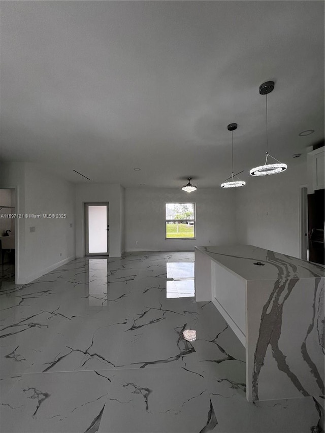 kitchen featuring pendant lighting and white cabinets