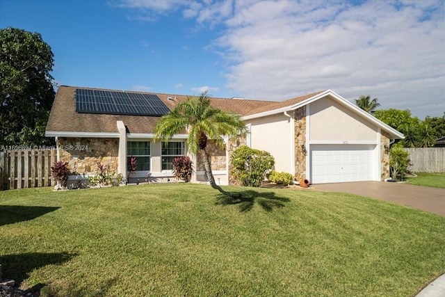 ranch-style home featuring solar panels, a garage, and a front lawn