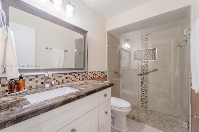 bathroom with tile patterned flooring, vanity, an enclosed shower, and decorative backsplash