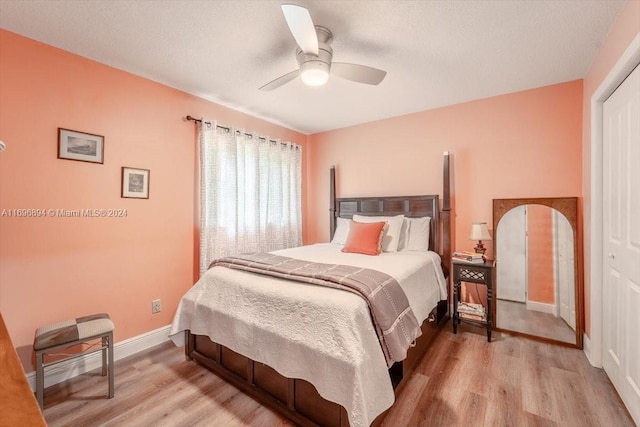 bedroom with light hardwood / wood-style floors, a closet, and ceiling fan