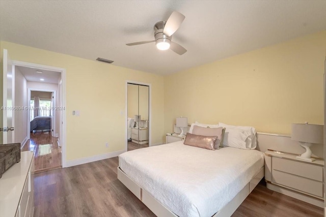 bedroom with ceiling fan, wood-type flooring, and a closet