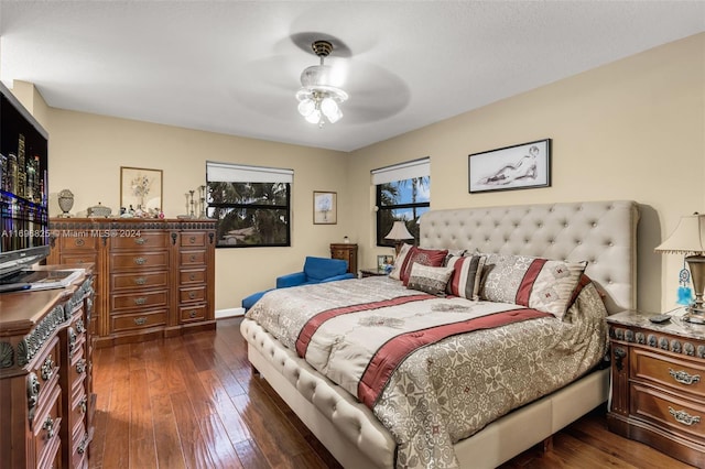 bedroom with ceiling fan and dark wood-type flooring