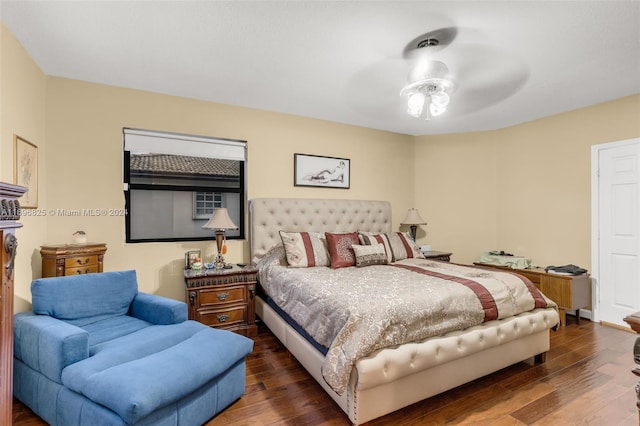 bedroom with ceiling fan and dark hardwood / wood-style flooring