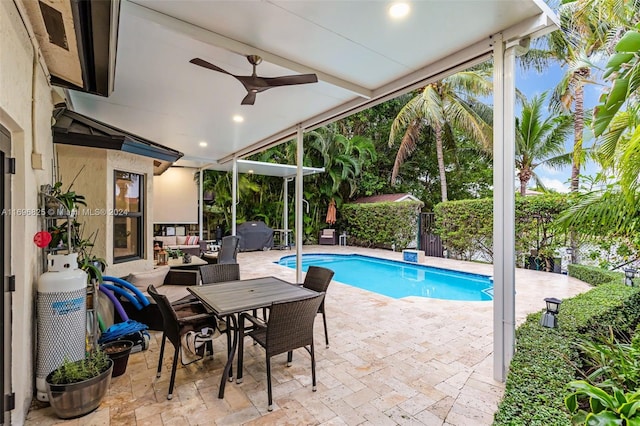 view of swimming pool with outdoor lounge area, ceiling fan, and a patio