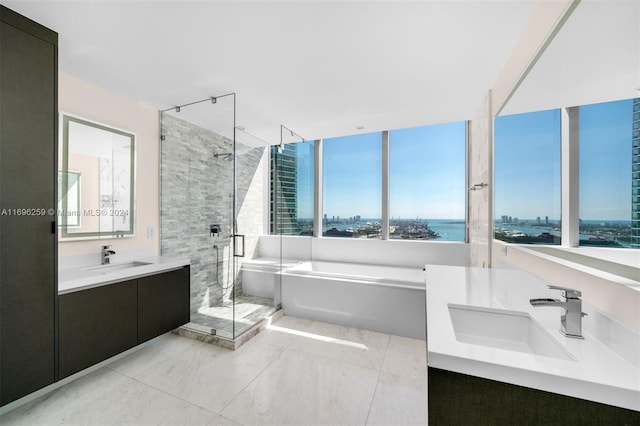 bathroom featuring vanity, a water view, and shower with separate bathtub