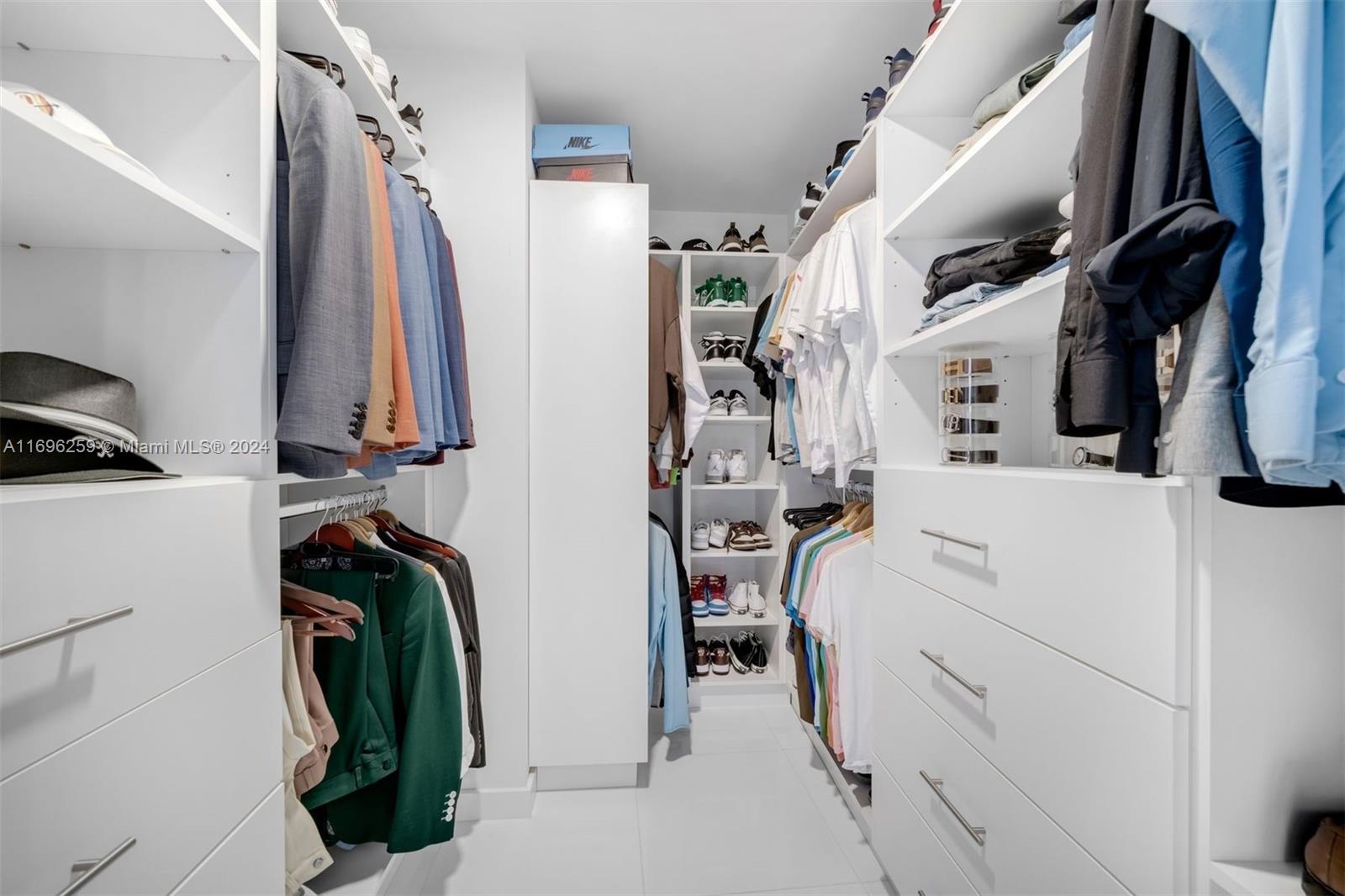 walk in closet with light tile patterned floors