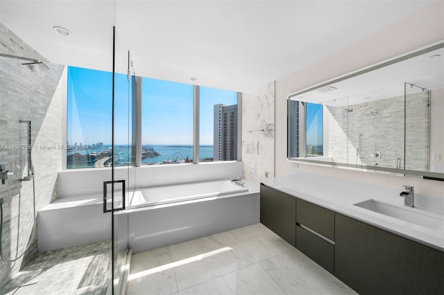 bathroom with separate shower and tub, vanity, tile patterned flooring, and a water view