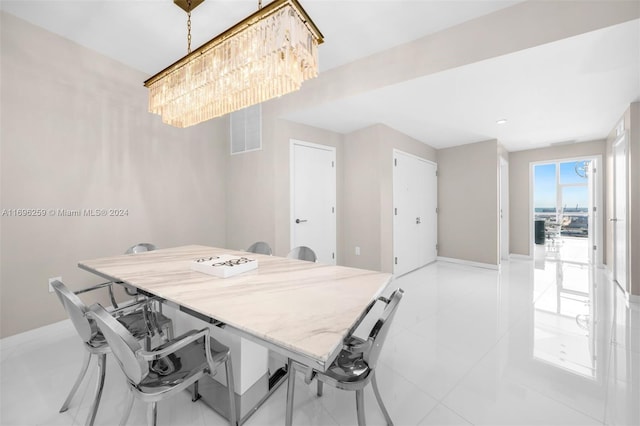 tiled dining area with a notable chandelier