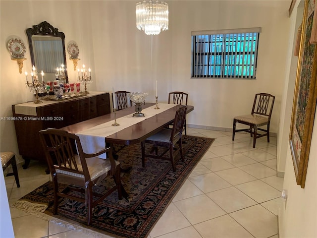 dining room with a chandelier and light tile patterned flooring